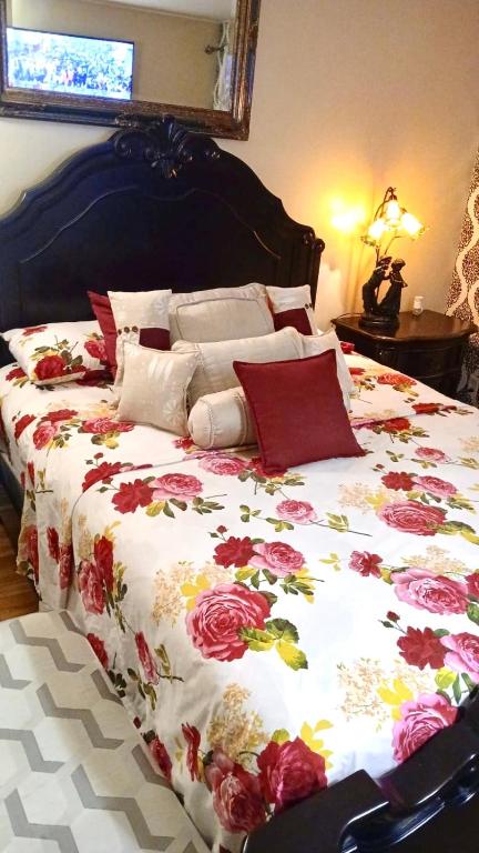 a large bed with a floral comforter on it at Refuge Appartement in Montreal