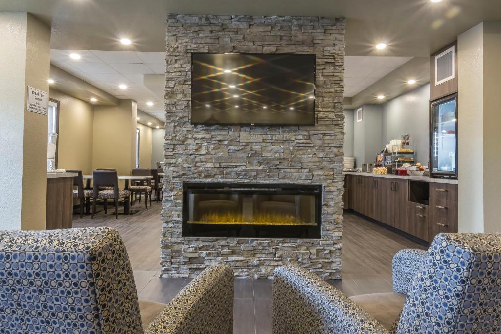 a lobby with a fireplace with a tv on top at Quality Inn & Suites in Moose Jaw