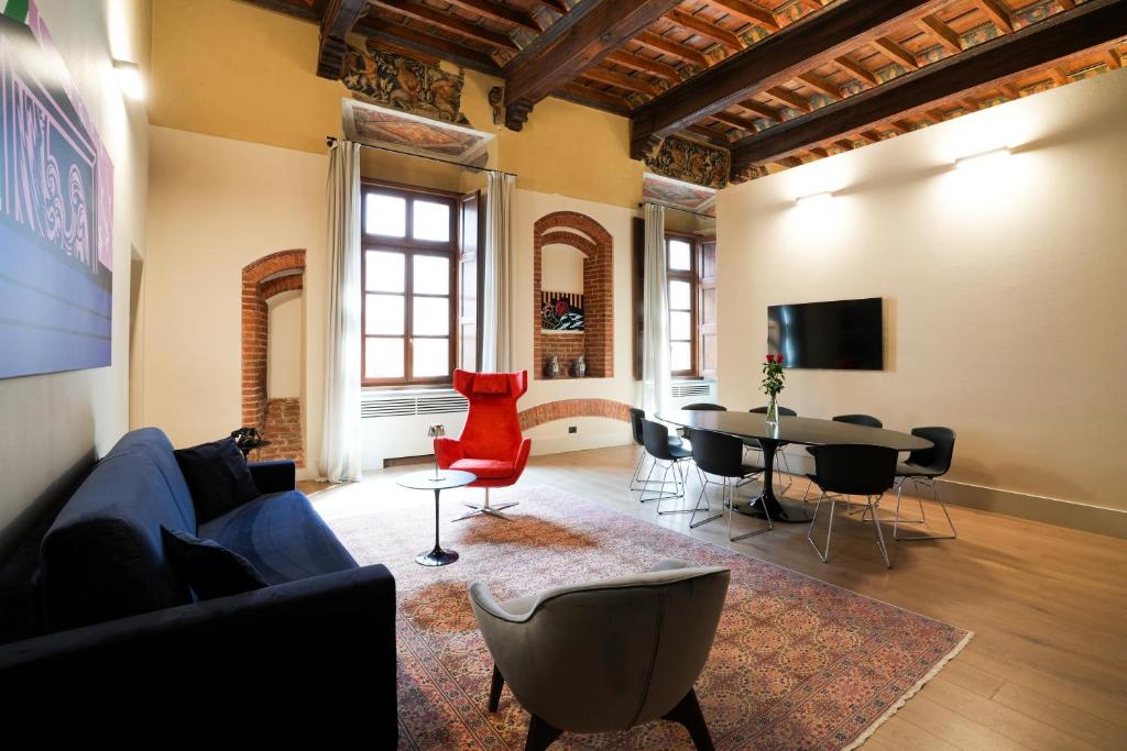 a living room with a couch and a table at Palazzo Zoya - Elegant Historic Suites - Asti Center - Near Langhe & Monferrato in Asti