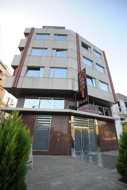 a building with a sign on the front of it at Carol Hotel in Piraeus