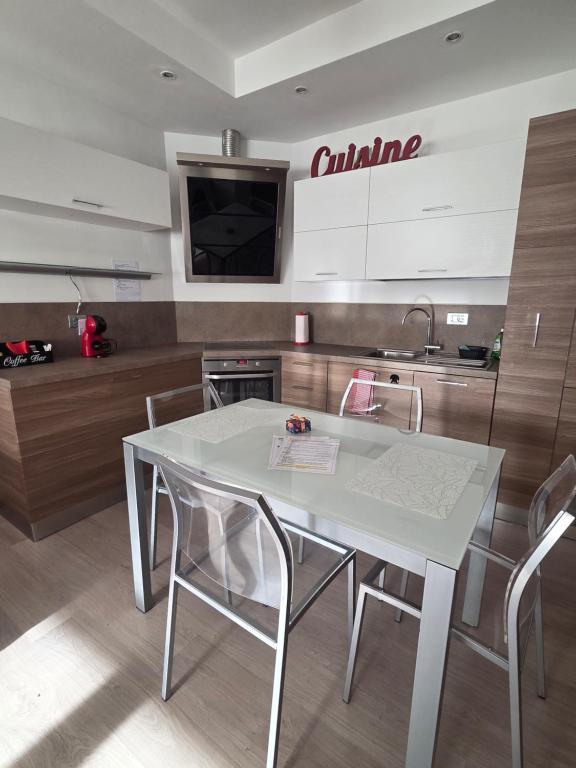a white dining room table with chairs in a kitchen at Il Ciano in Sondrio
