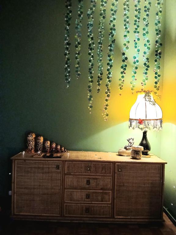 a table with a lamp and a wall with beads at RaMaya, casa d'artista in Biella