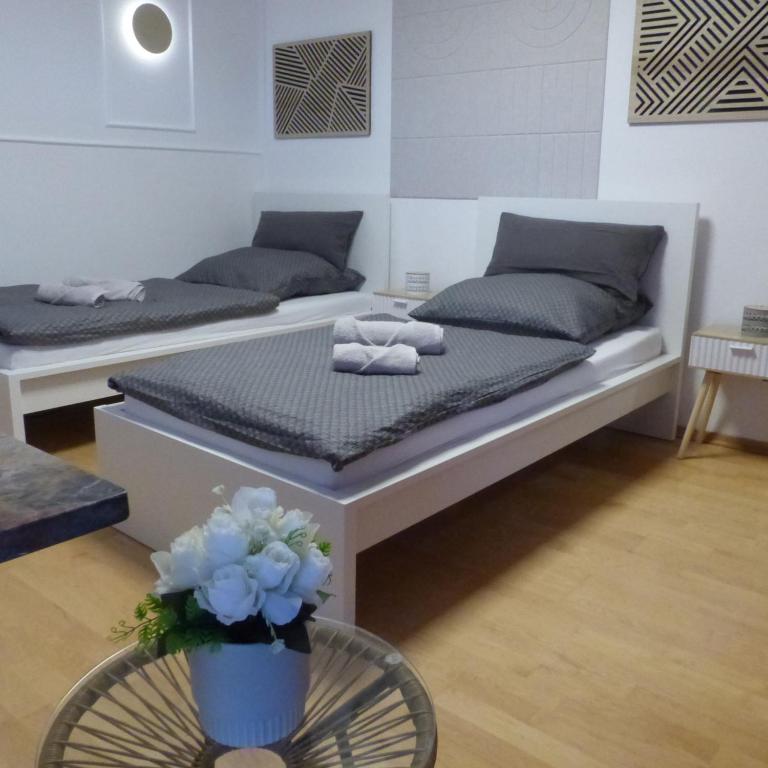 ein Zimmer mit zwei Betten und einem Tisch mit Blumen in der Unterkunft ChrisTho - Am Rheinsteig in Vallendar