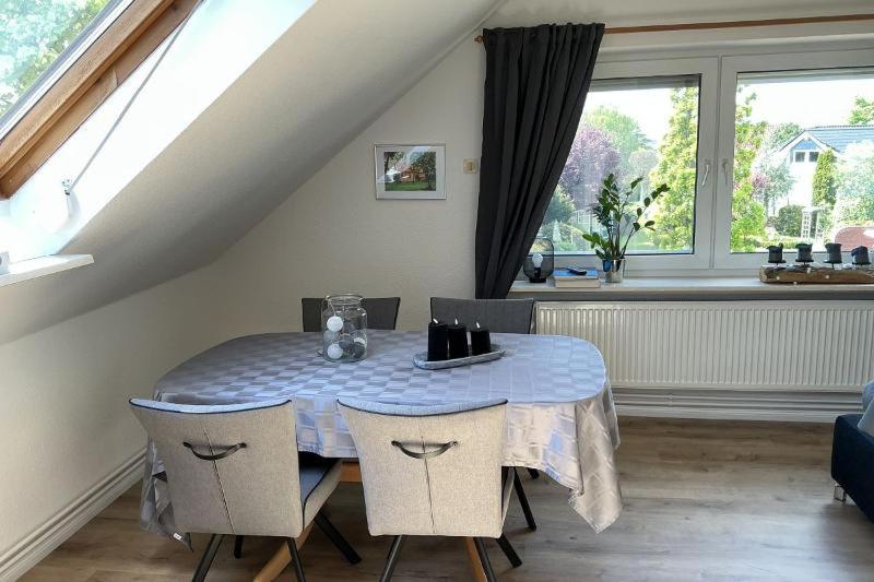 a dining room with a blue table and chairs at FewoConny in Hattstedt