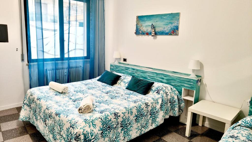 a small bedroom with a bed and a window at Casa Mario in Loano