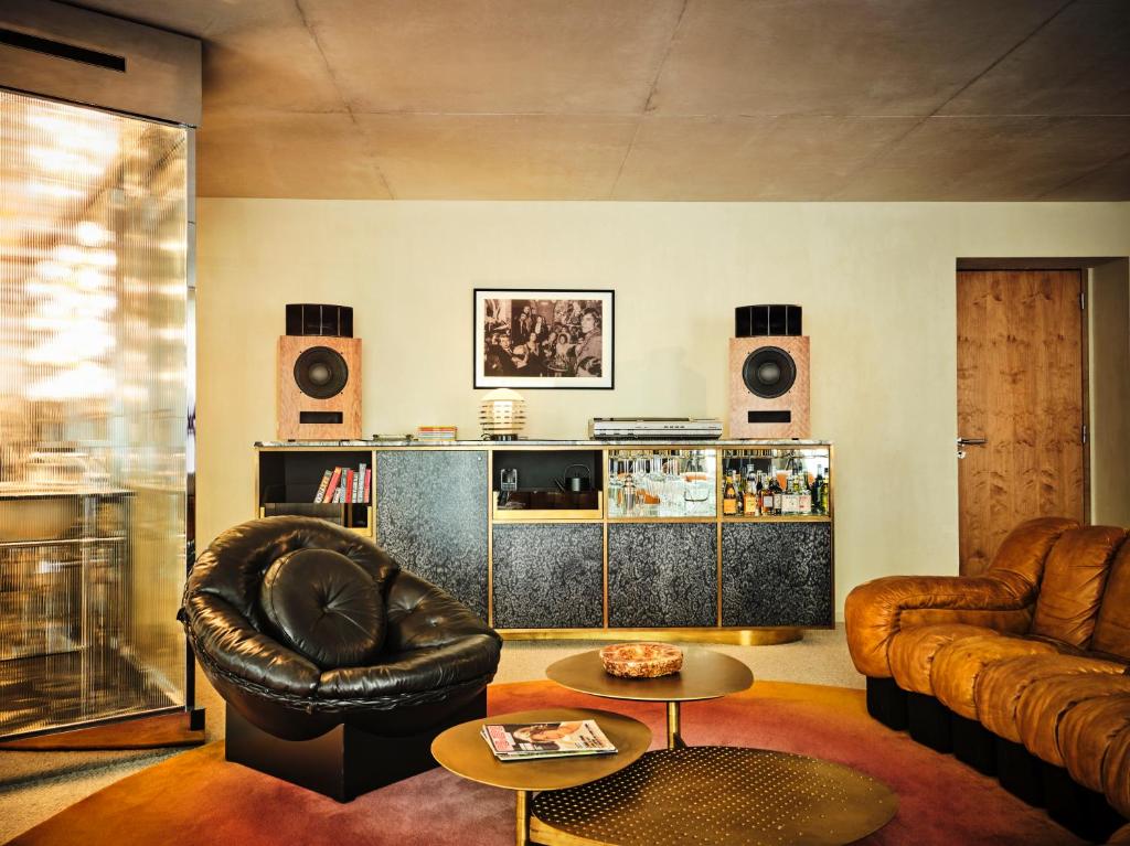 a living room with a leather couch and a table at Bus Palladium in Paris