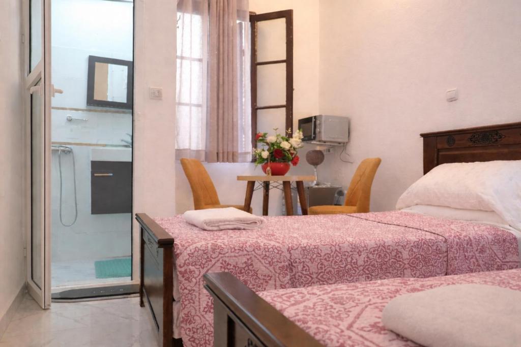a bedroom with a bed and a table with chairs at Tangier city center 3 in Tangier