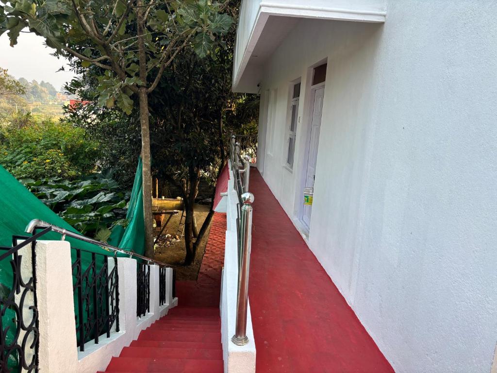 a stairway leading to a white building with a white door at Happy Hills in Yelagiri