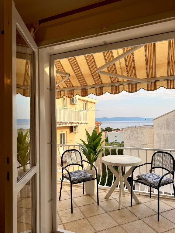 a balcony with a table and chairs and a table at Apartments Robert in Tučepi