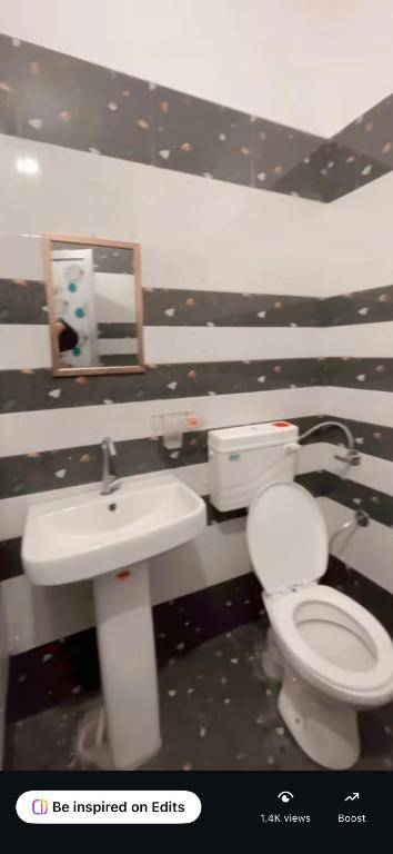 a bathroom with a toilet and a sink at Platinum hotel in Bhucho