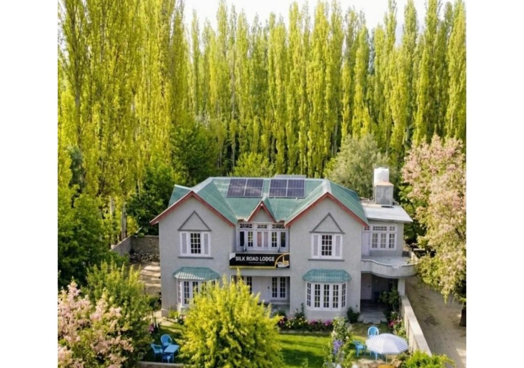 an aerial view of a house with trees in the background at Rus Olive Lodge Skardu in Skardu