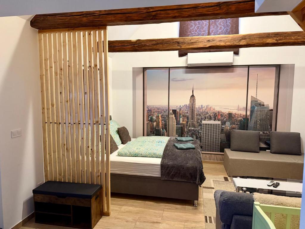 a bedroom with a bed and a view of a city at Biró Vendégház in Sármellék