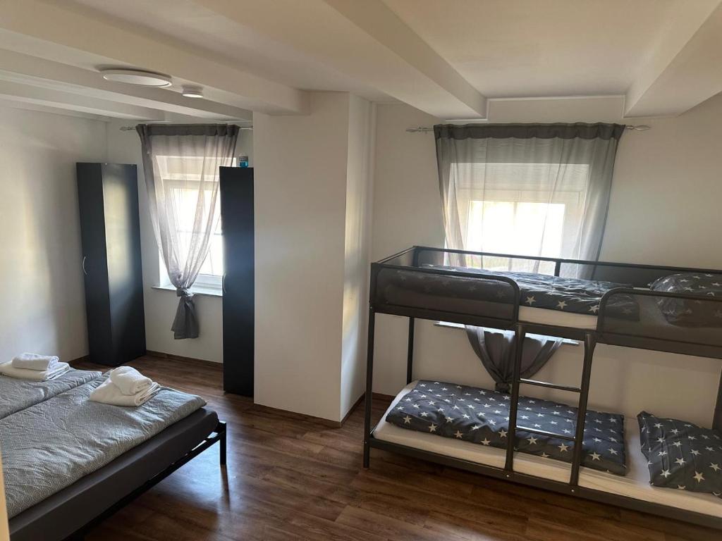 a room with two bunk beds and a bed at R&B pension in Ichenhausen