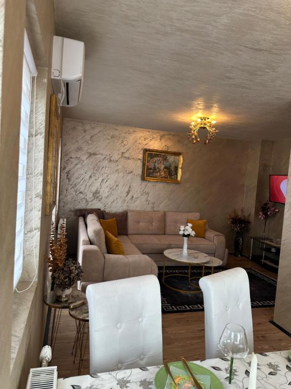 a living room with a couch and a table at Christian Dior Lazarevac in Lazarevac