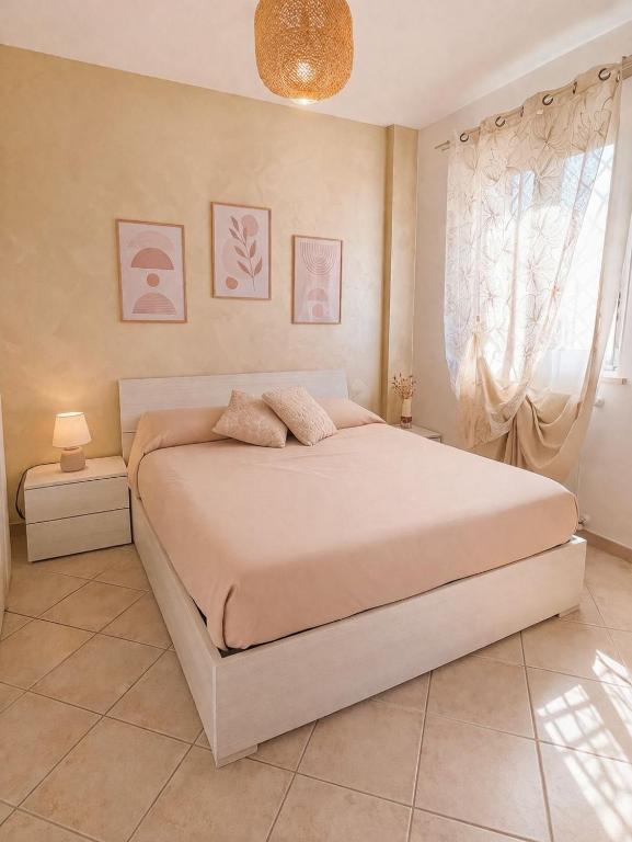 a bedroom with a large bed and a window at Il Borghetto in Ciampino