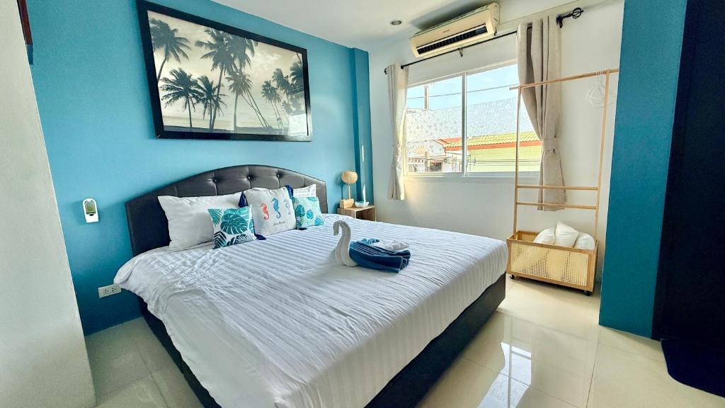a blue bedroom with a bed with a blue wall at DANK Hotel 420 friendly Patong Phuket in Patong Beach