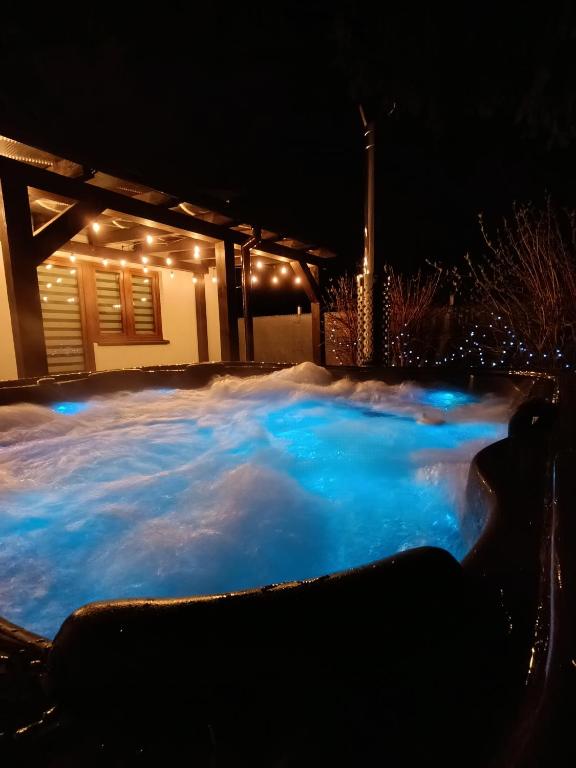 a hot tub covered in snow at night at Apartament Chyża , jacuzzi , taras , parking in Zamość
