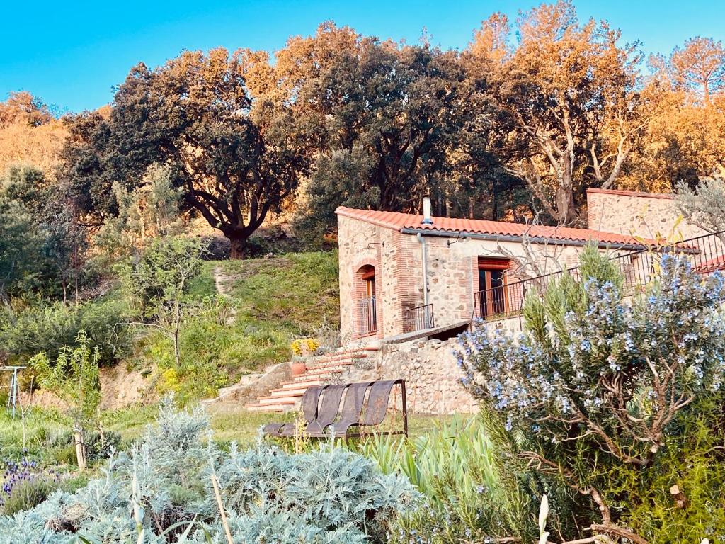 a stone house in the middle of a field at Mas Saint Michel in Vivès