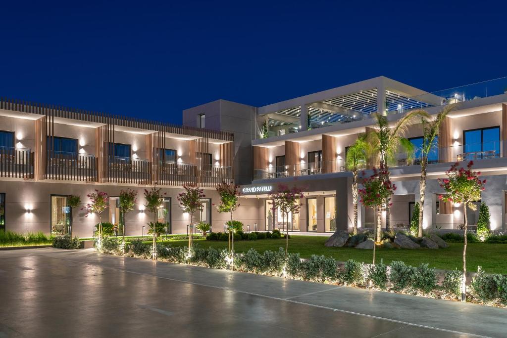 an exterior view of a building at night at GRAND PATELLI in Myrina
