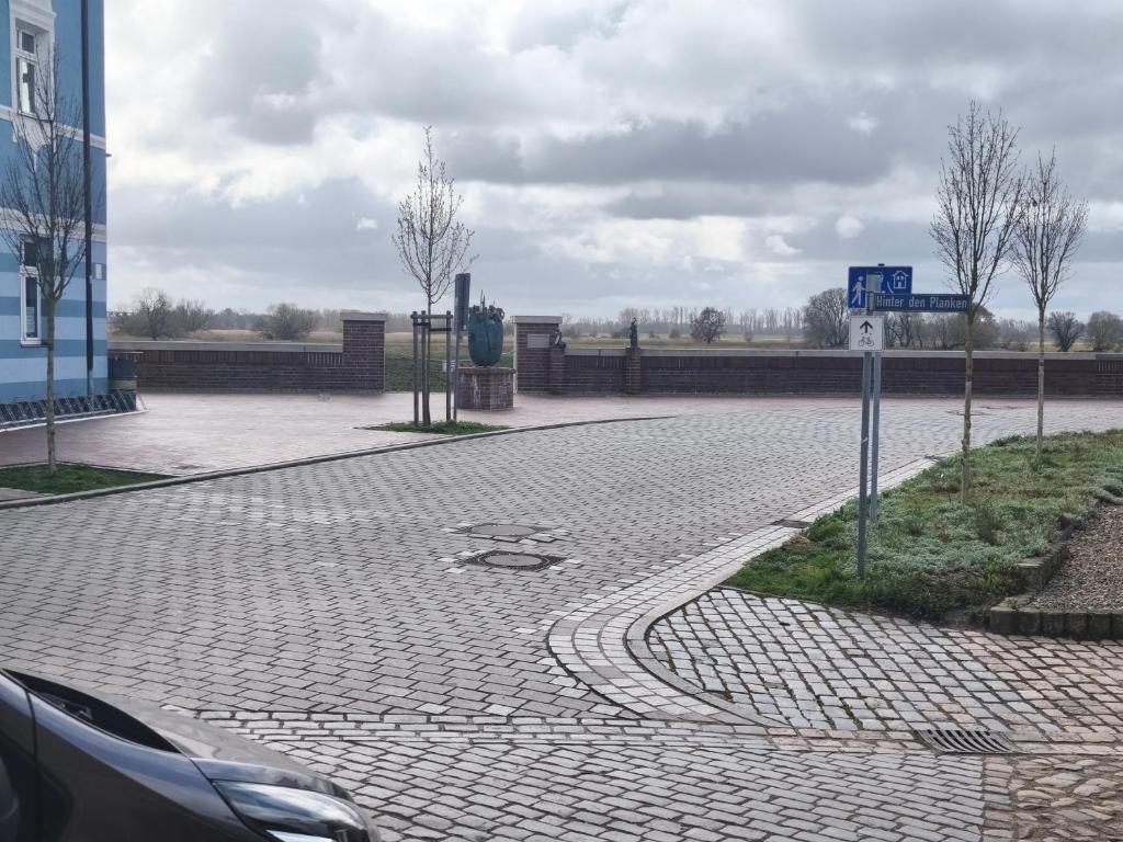 a brick road with a car parked on it at Wohnung Burgstraße in Wittenberge