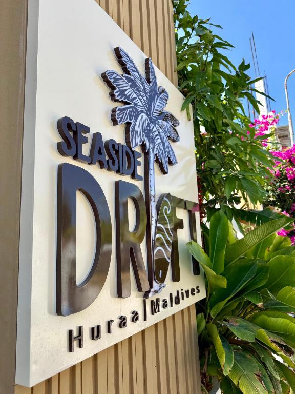 a sign for a seaside dip huahanna maliates at Seaside Drift in Huraa