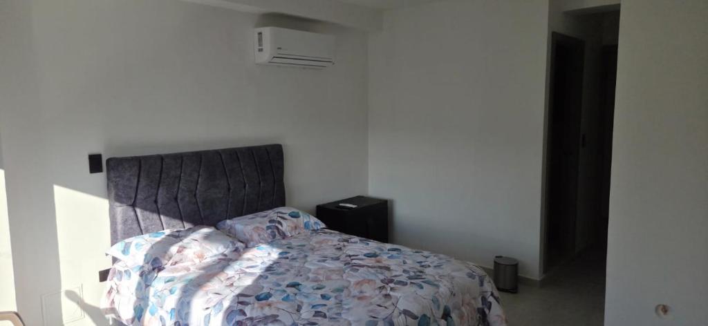 a bedroom with a bed with a comforter on it at Don Pedro in Buga