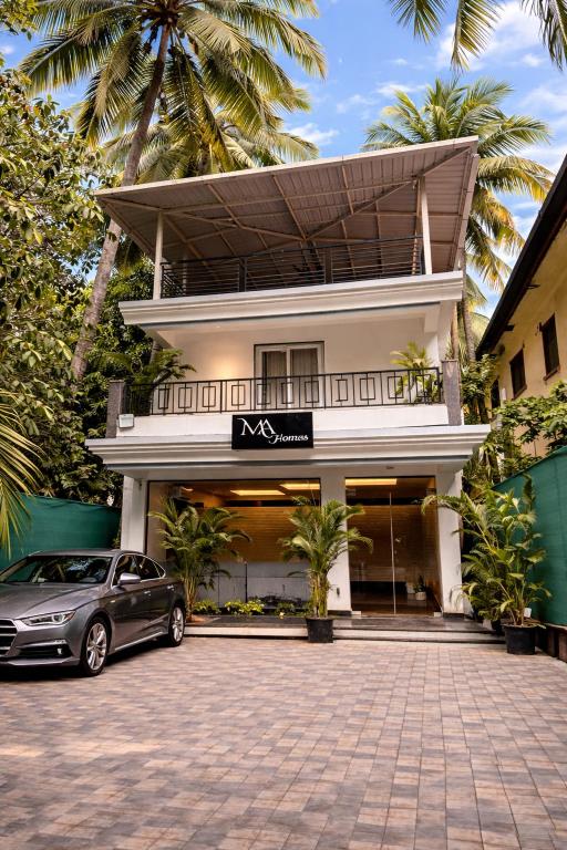 a car parked in front of a building at Marshmallow - by MA Homes in Morjim