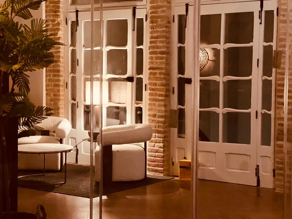 a living room with a chair and a table at Hotel Villa Ruy López in Zafra