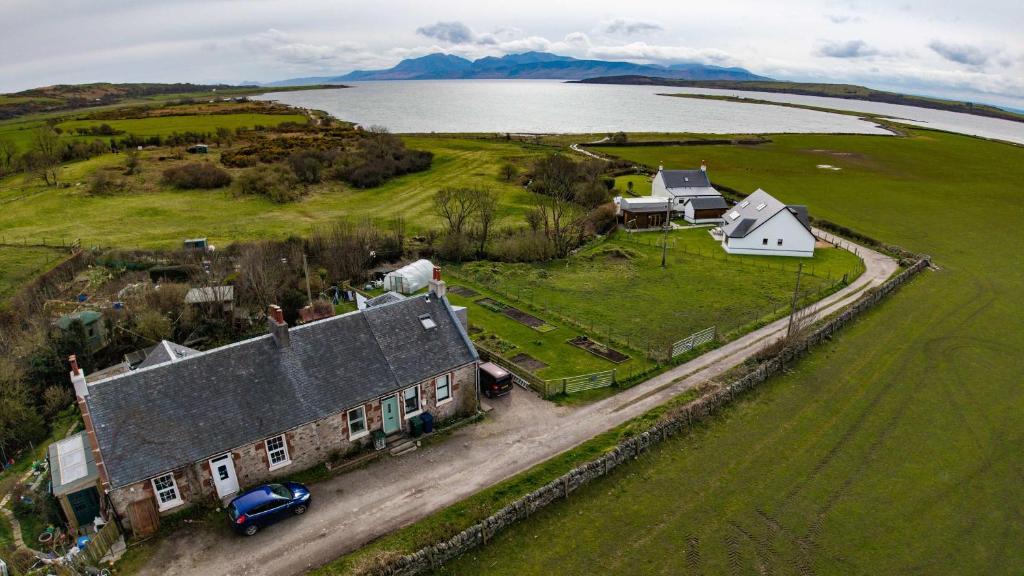 an aerial view of a house and a lake at The Stay at Straad in Island of Bute