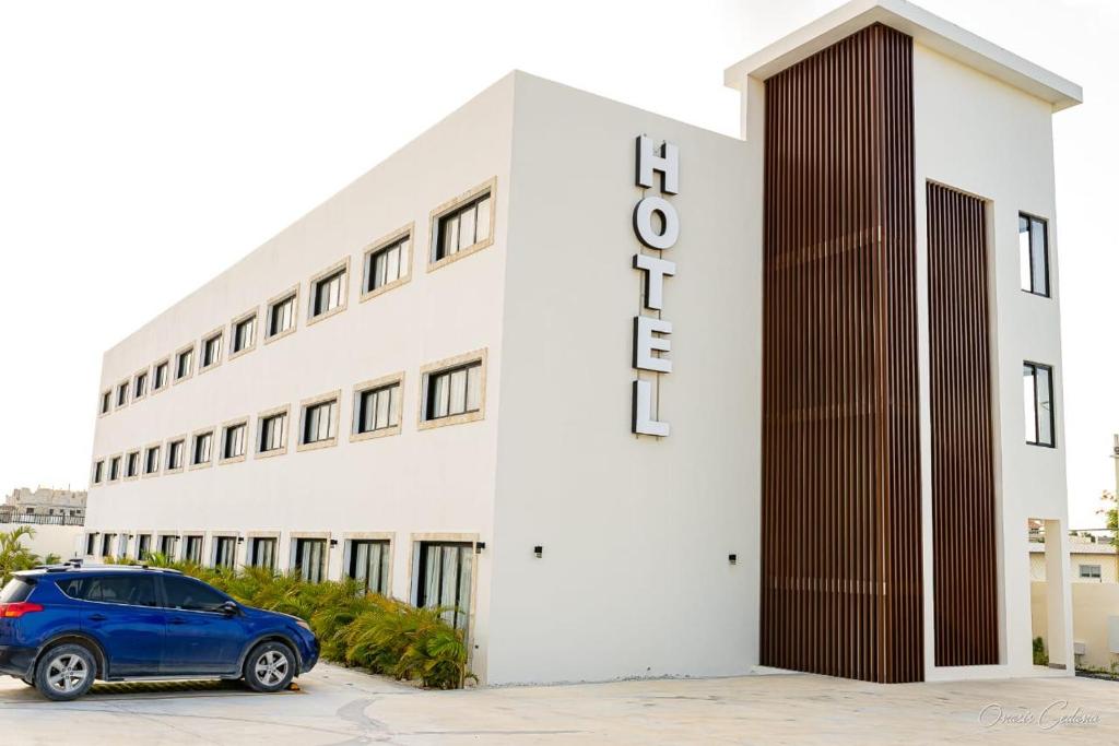a building with a car parked in front of it at Stars Hotel Bavaro in Punta Cana