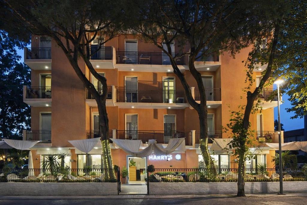 a building with a sign on the front of it at Hotel HARRY'S Hospitality Riccione-Fronte Mare in Riccione