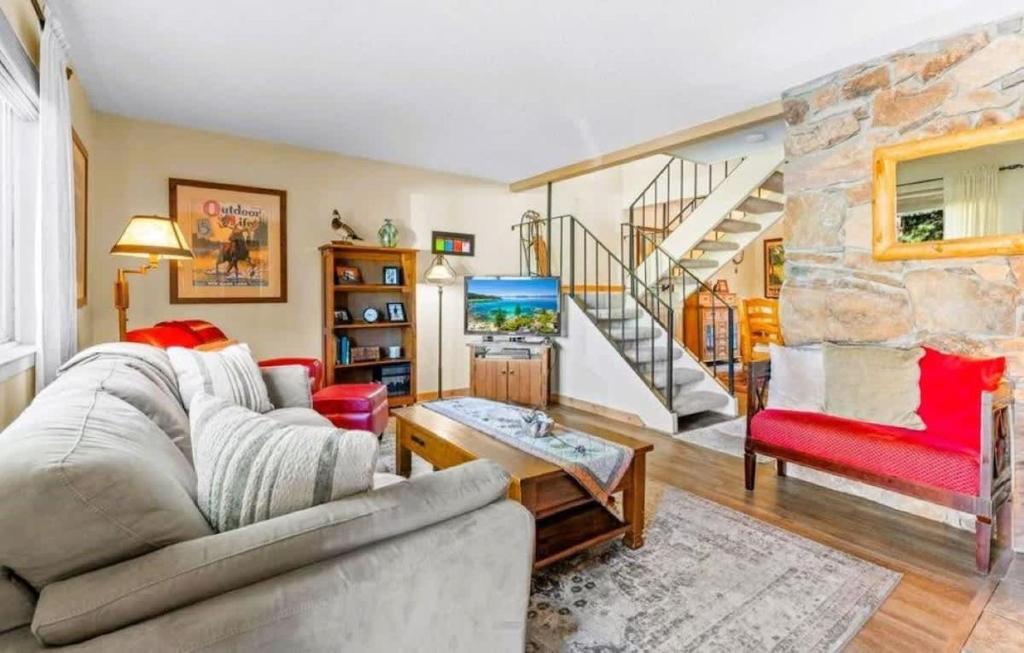 a living room with a stone wall at Cozy Bear's Lair in Tahoe City
