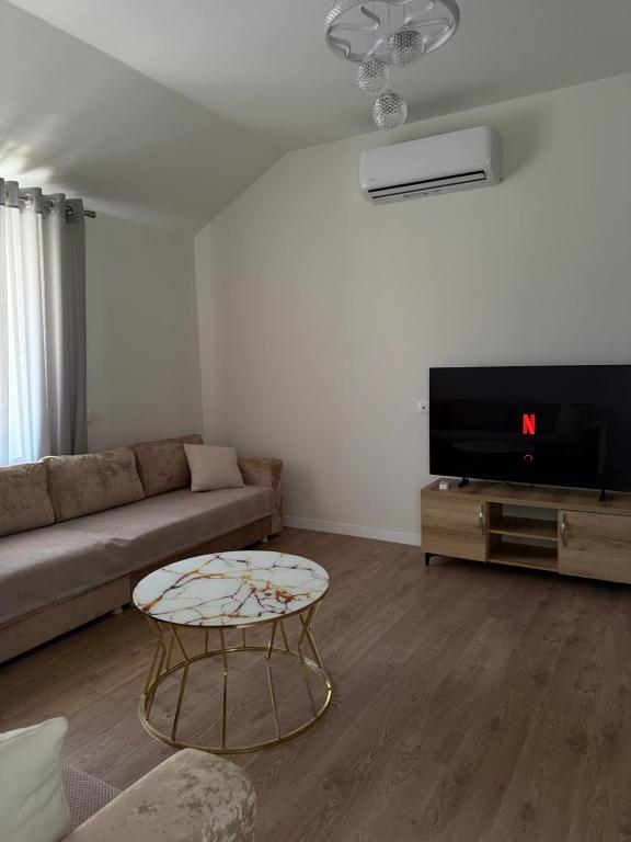 a living room with a couch and a coffee table at Olivea Suites Tirana in Tirana
