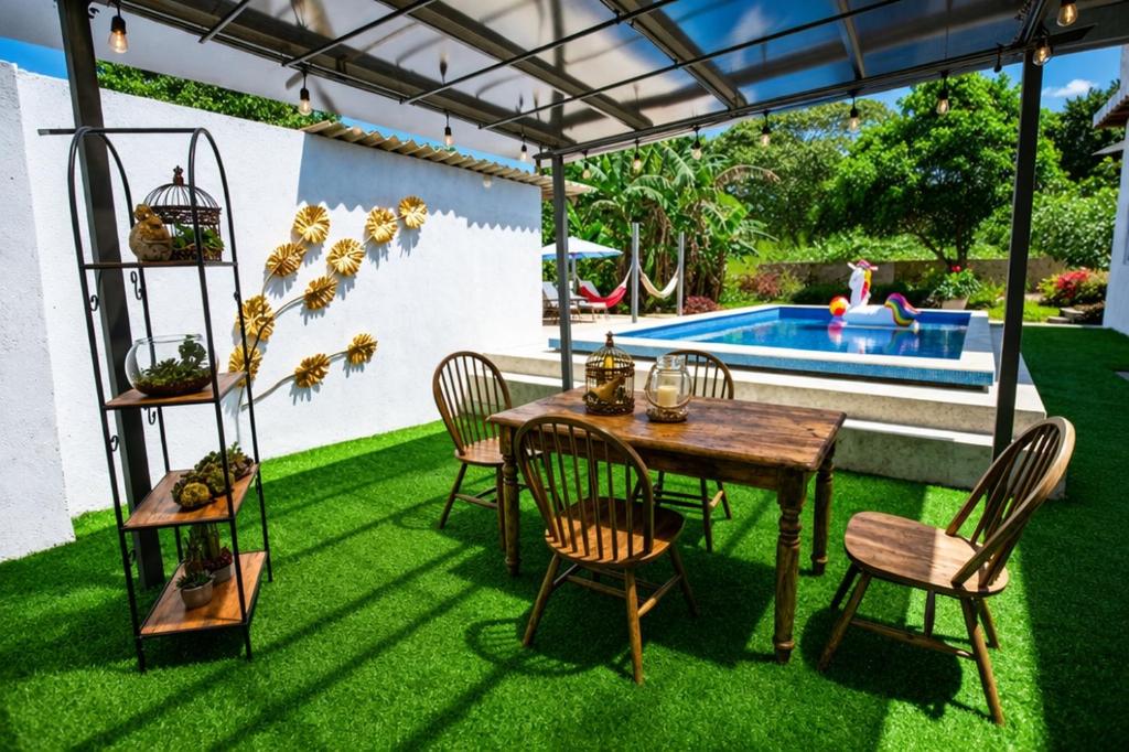 a patio with a table and chairs and a pool at Amancay House, Jacuzzi and Pool in San Cristóbal