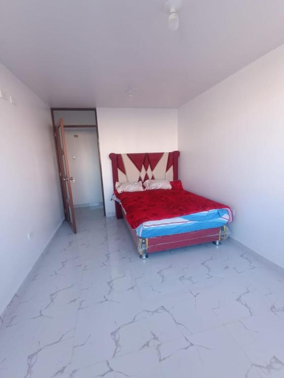 a room with a bed in a room with a door at Casa Blanca in Ayacucho