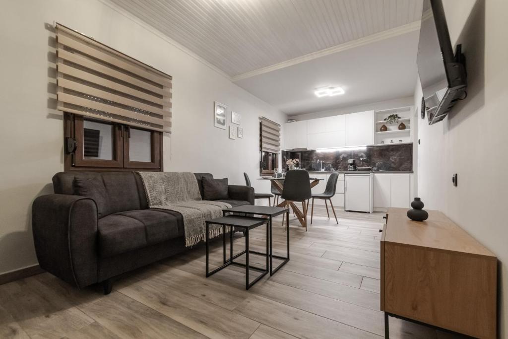 a living room with a couch and a table at Casa Calma in Volos