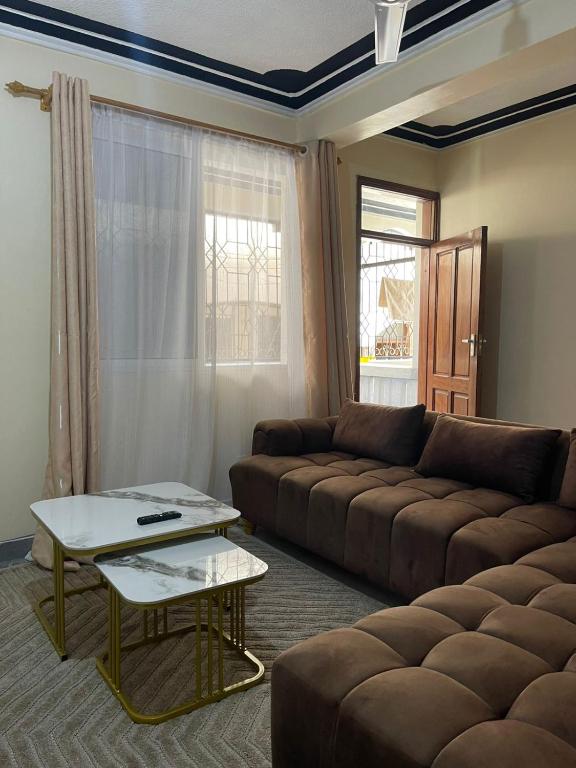 a living room with a couch and a coffee table at Honned homes in Mombasa