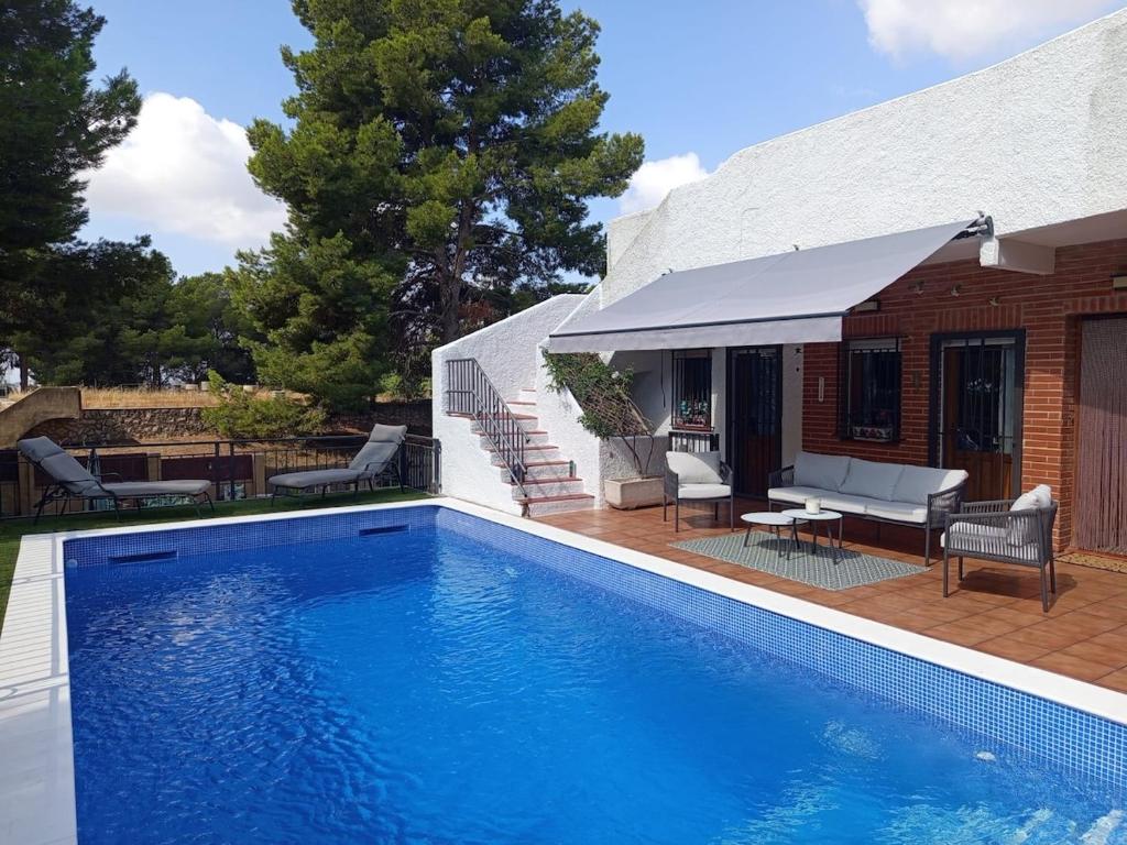 a swimming pool in front of a house at Casa Azahar in Lliria