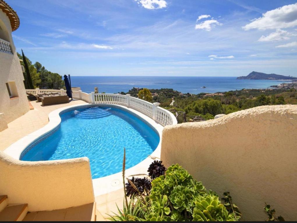 a large swimming pool sitting next to a building at Altea Hills Best Seaview in Altea