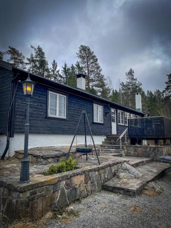 a house with a playground in front of it at Cabin Lyseren in Omberg