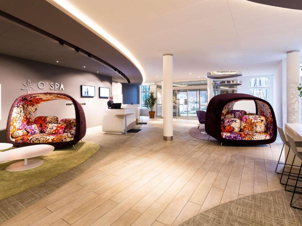 a room with two chairs and furniture in a store at Novotel Resort & Spa Biarritz Anglet in Anglet