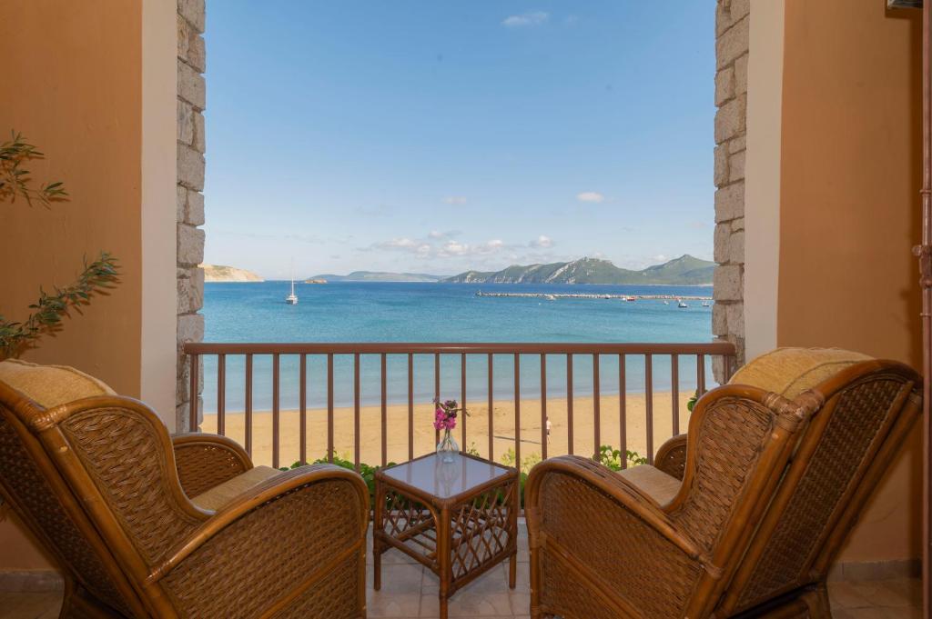 a balcony with chairs and a view of the beach at Methoni Beach Hotel in Methoni