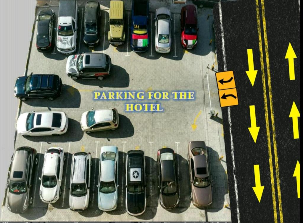 a group of cars parked in a parking lot at Sara Hotel Apartments in Ajman 