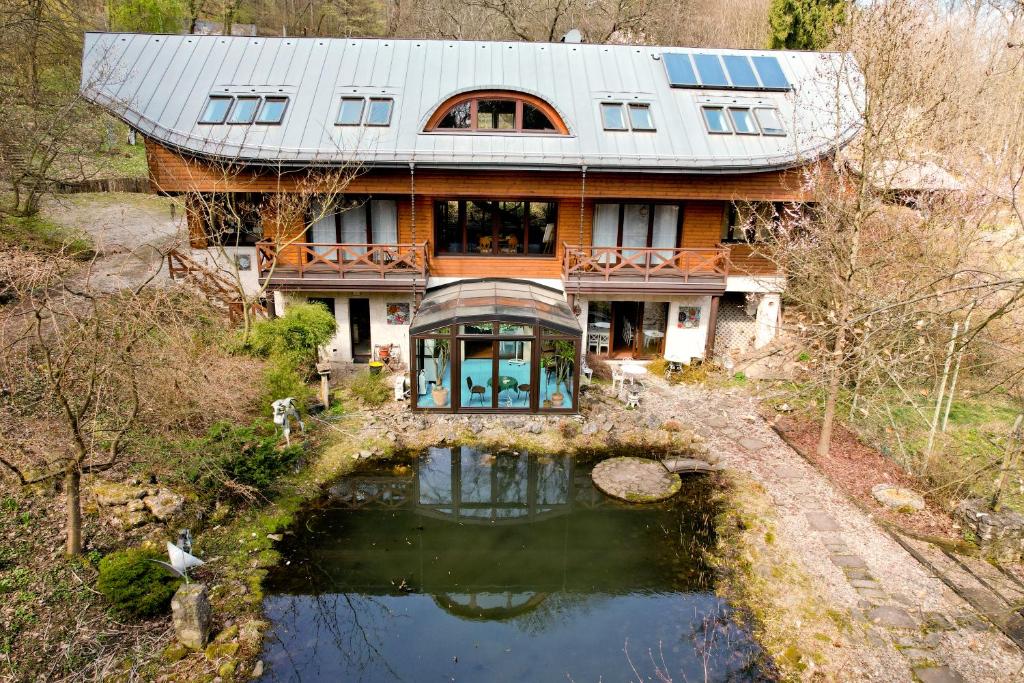 an aerial view of a house with a pond at Ekosamotnia in Krakow