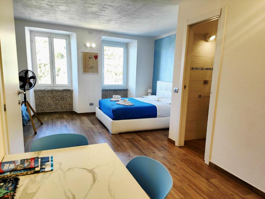 a bedroom with a bed and a table and chairs at Casa Mafalda in Manarola