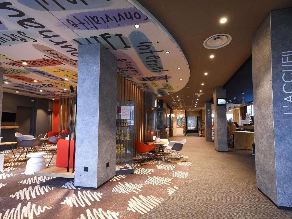 a lobby with chairs and tables in a building at ibis Dijon Gare in Dijon