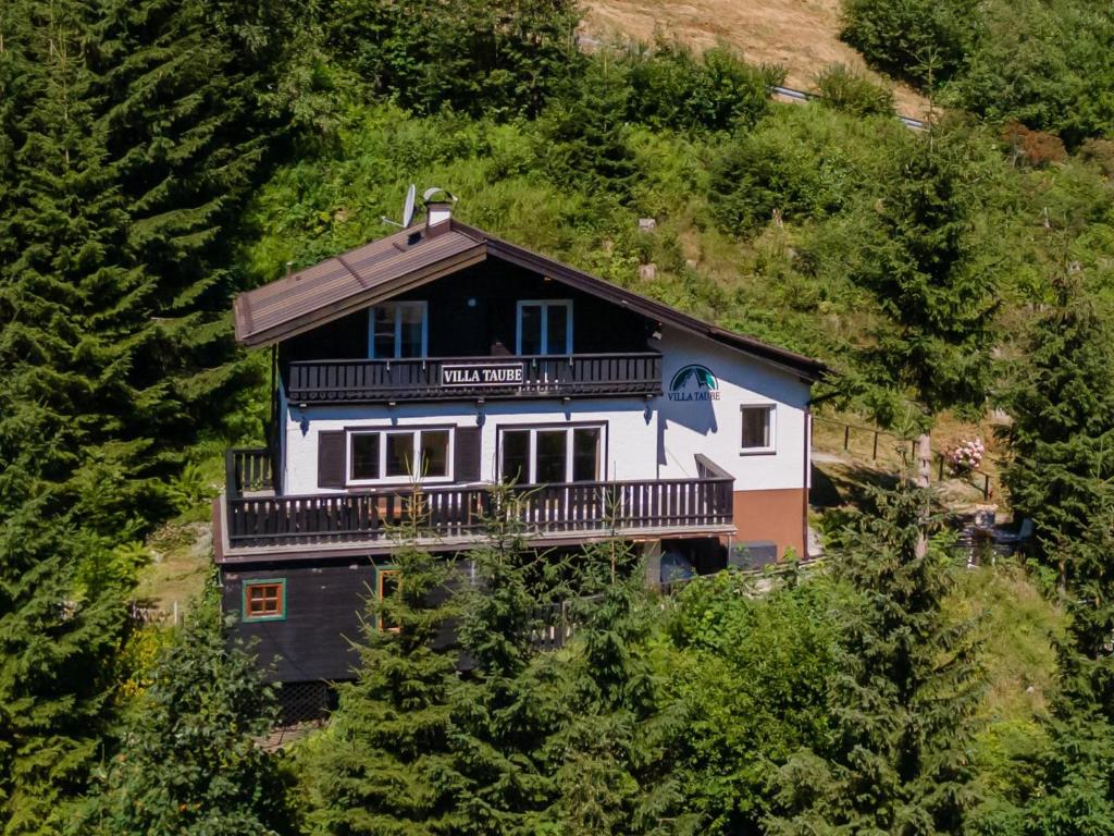 a house on the side of a hill with trees at Villa Taube XL in Bad Gastein