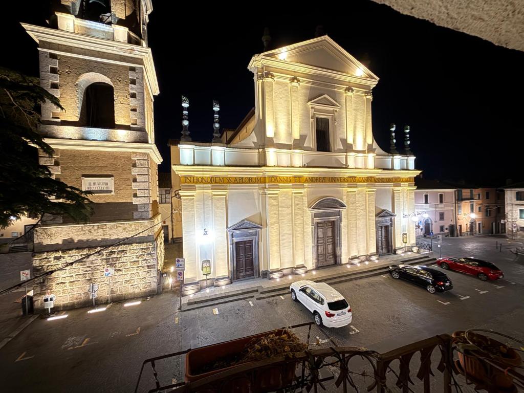 a white van parked in front of a building with a clock tower at Casa Di Carla in Canino