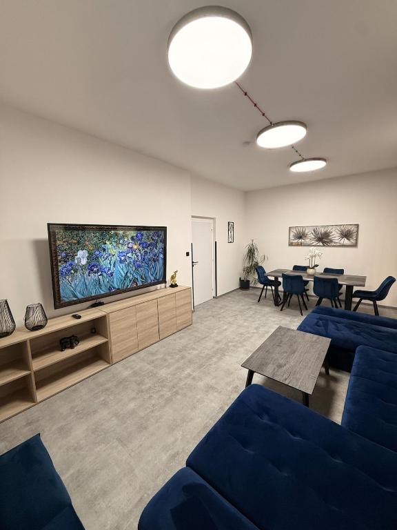 a living room with a large flat screen tv at Teplice Apartments 2 in Teplice