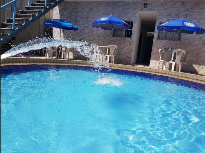 a large swimming pool with a fountain in a hotel at 14km de tambau in Cabedelo